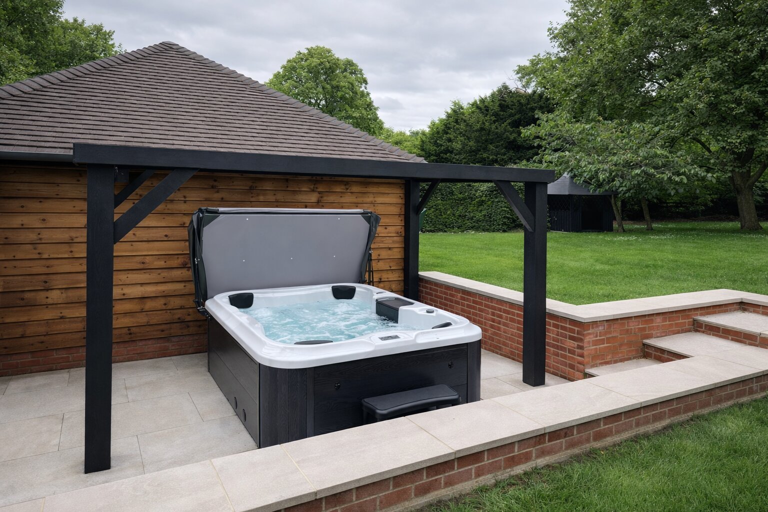 Hot tub under a wooden pergola with a garden setting
