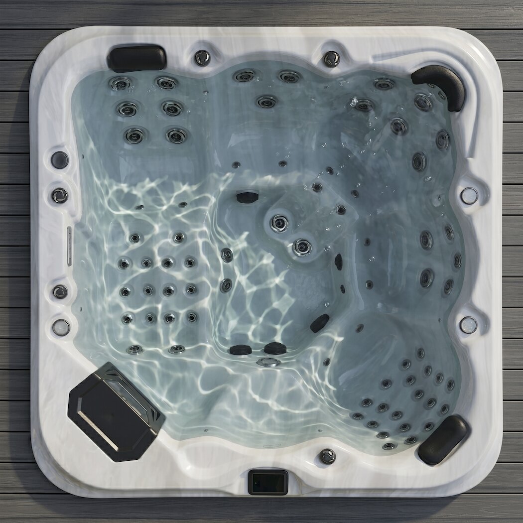 Top-down view of a hot tub with water on a wooden deck