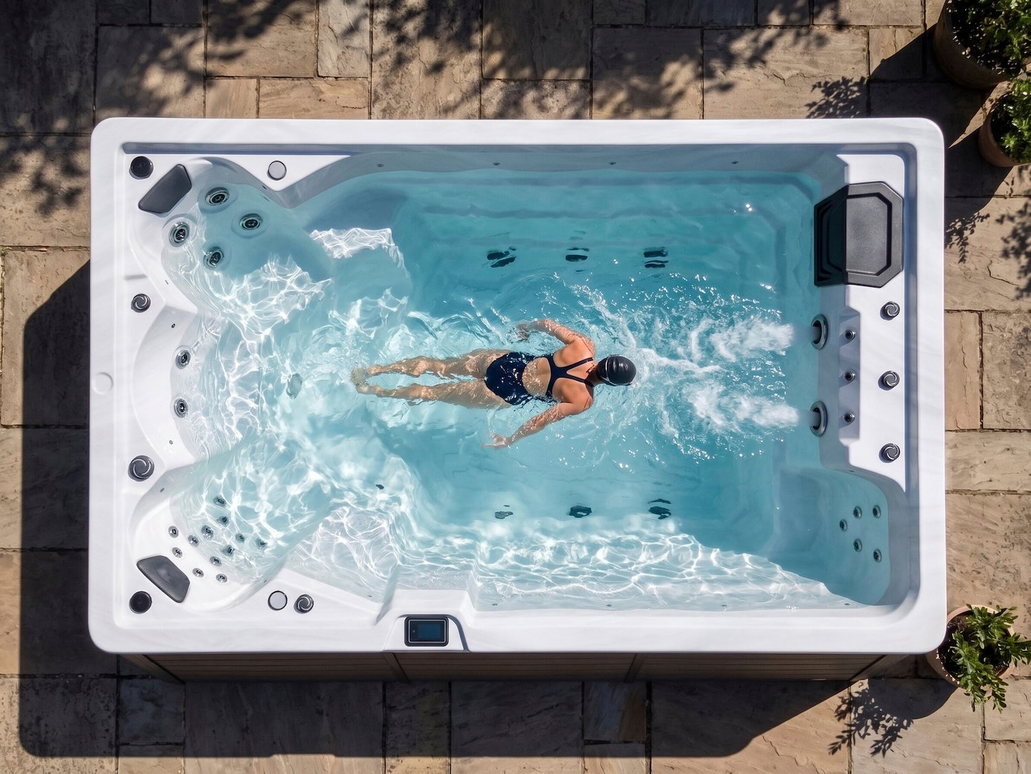 Person swimming in a swim spa