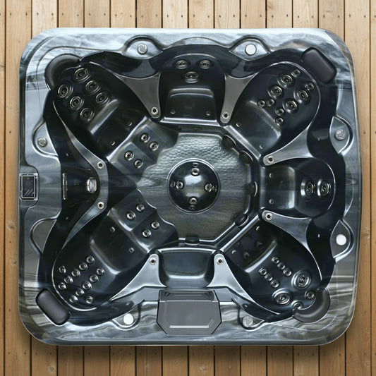 Top view of a hot tub shell on a wooden floor