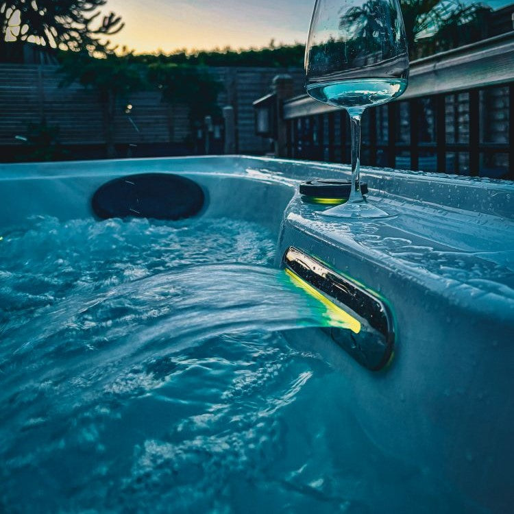 Hot tub waterfall with glass of wine