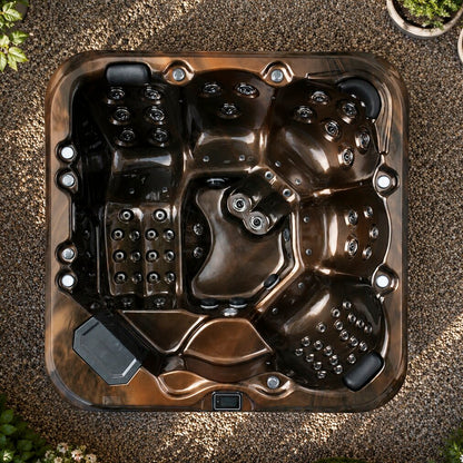 Top-down view of a hot tub on a gravel surface