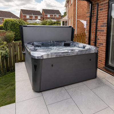 Hot tub on a patio area with a residential background