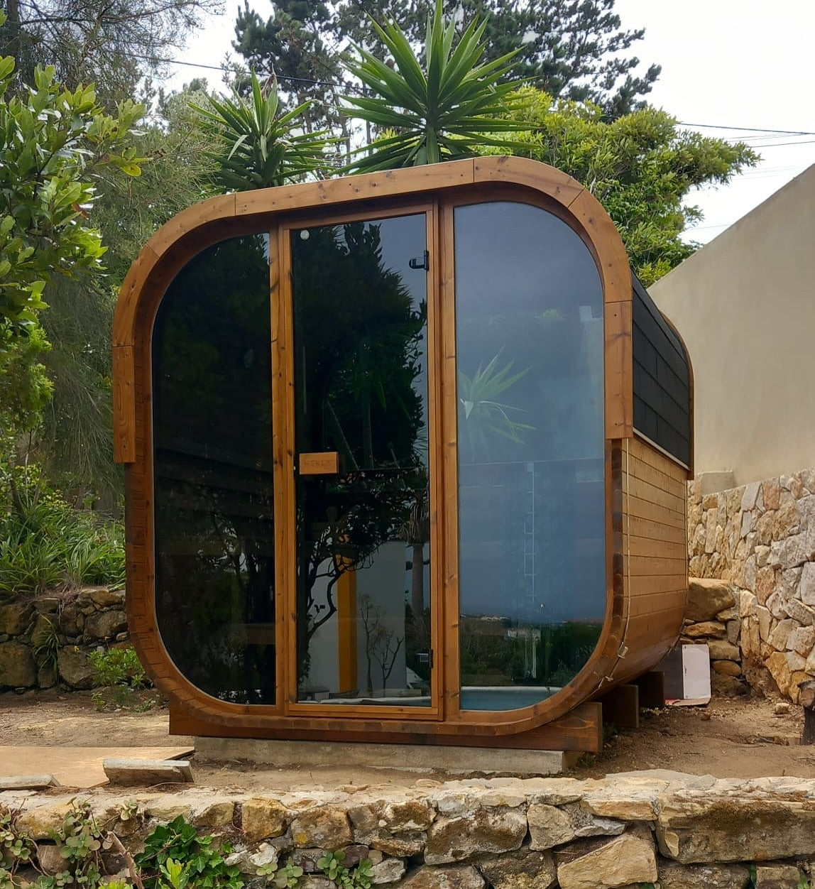 Cube 250 outdoor sauna in a garden