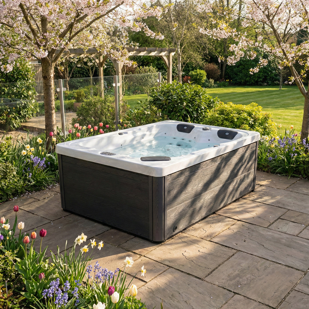 Hot tub in a garden setting with flowers and trees