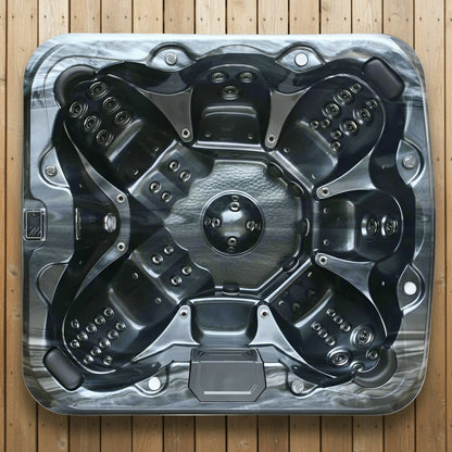 Top view of a hot tub shell on a wooden floor