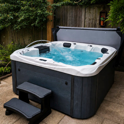 Retreat Plus hot tub with water and steps in a garrden setting