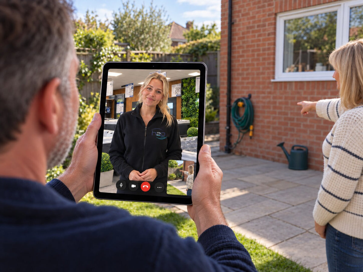 Couple having a virtual hot tub appointment, showing the salesperson their garden space